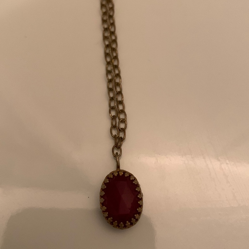 Gold necklace with red stone pendant